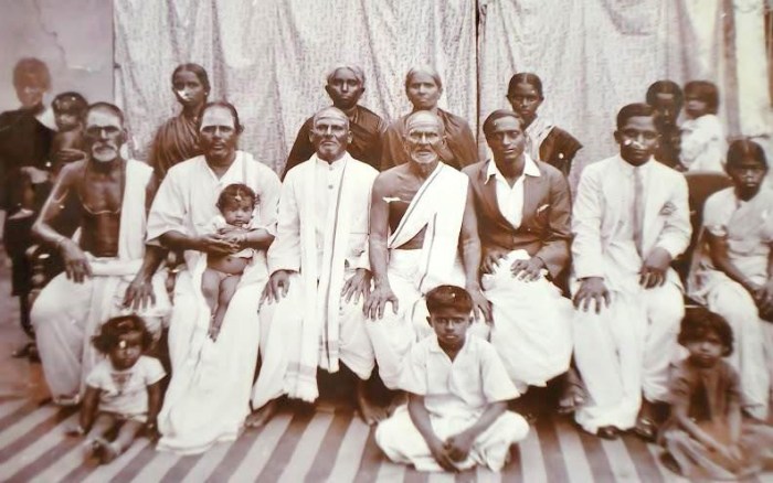 My mother's paternal grandfather, my great-grandfather, N. Kuppuswamy, is seated in the centre. He is wearing an angavastram or upper garment. His wife and my great grandmother, Alamelu is standing behind him.