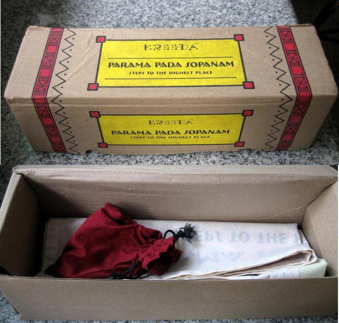 Top: The "boxed" game. Bottom: The box opens to reveal a little cloth pouch containing little wooden counters, two elongated metal dies, and an information booklet (not in picture)